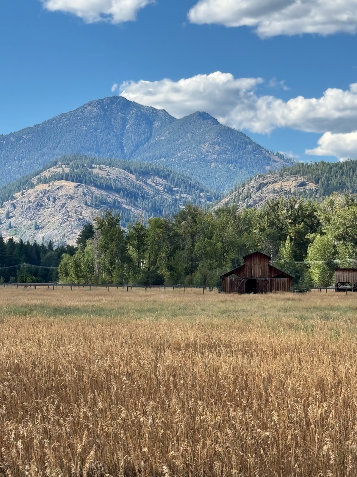 A historic red barn framed by a dramatic Methow peak — a rustic wedding venue